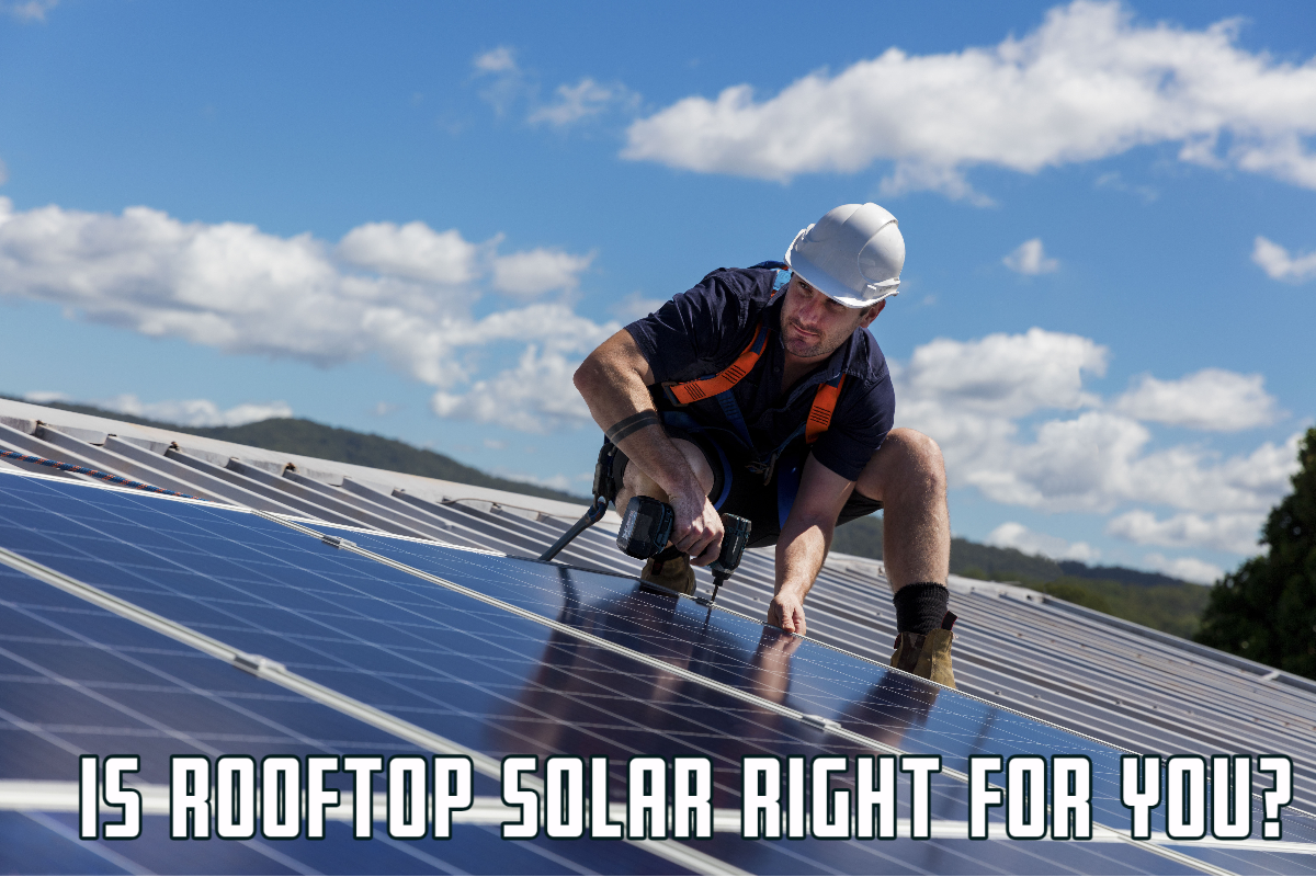 Technician on Rooftop Installing Solar Panels